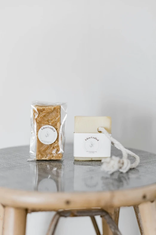 two packages sitting on a table in front of a wood table