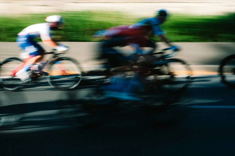 three people riding bicycles on street next to roadway