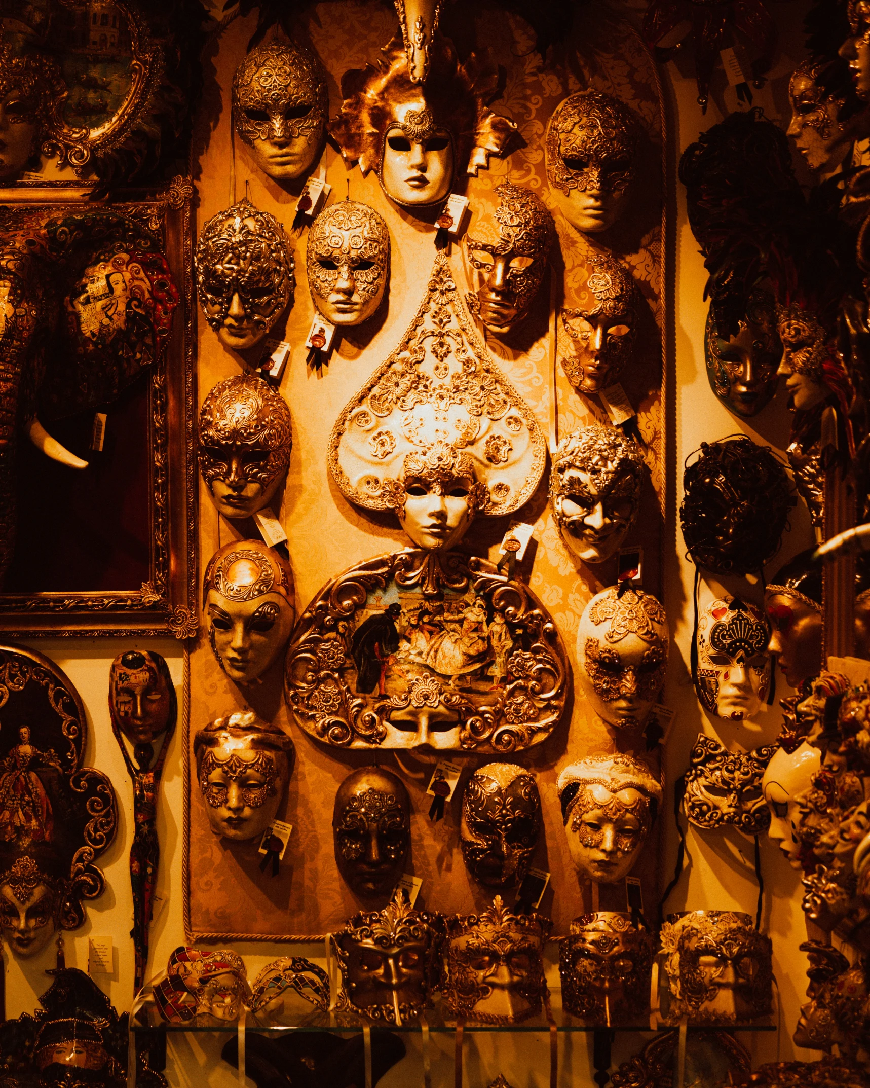 a wall full of golden masks is very ornate