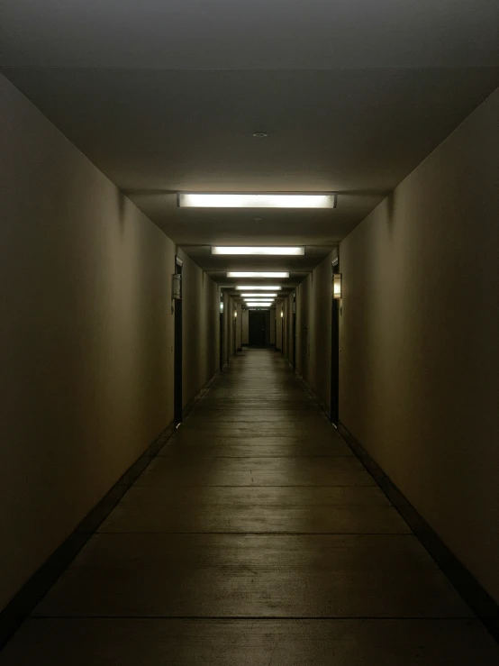 a narrow walkway inside of a dark building