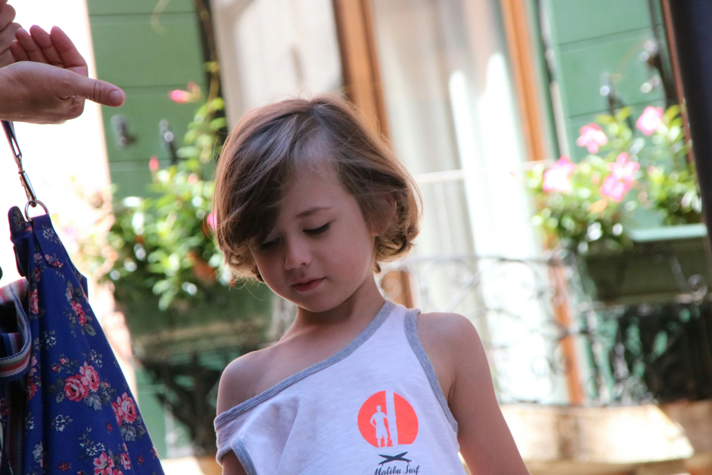 a little girl holding an object in her hands