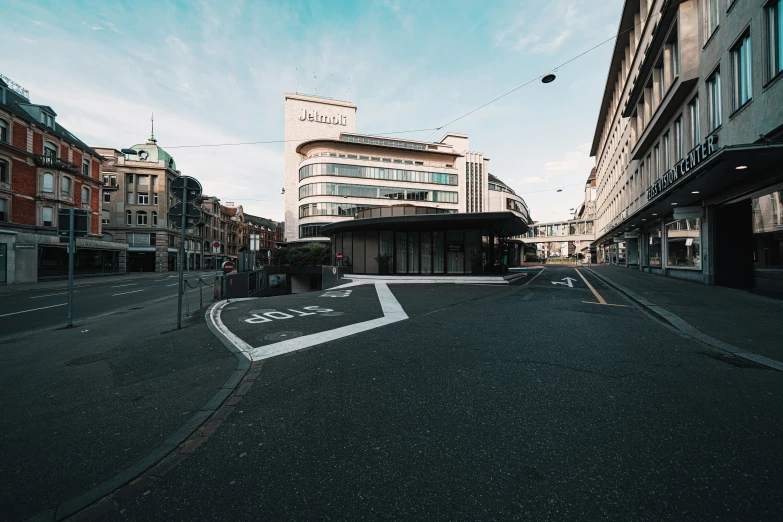 an empty street and the entrance to an office building