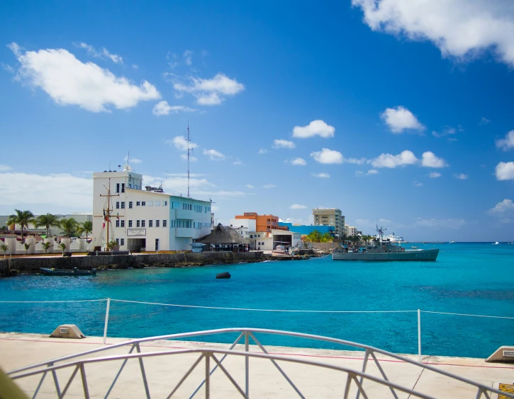 a small fishing village by the ocean, surrounded by blue waters