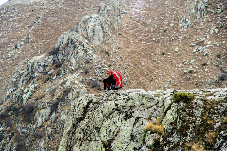 a man walking on the side of a mountain
