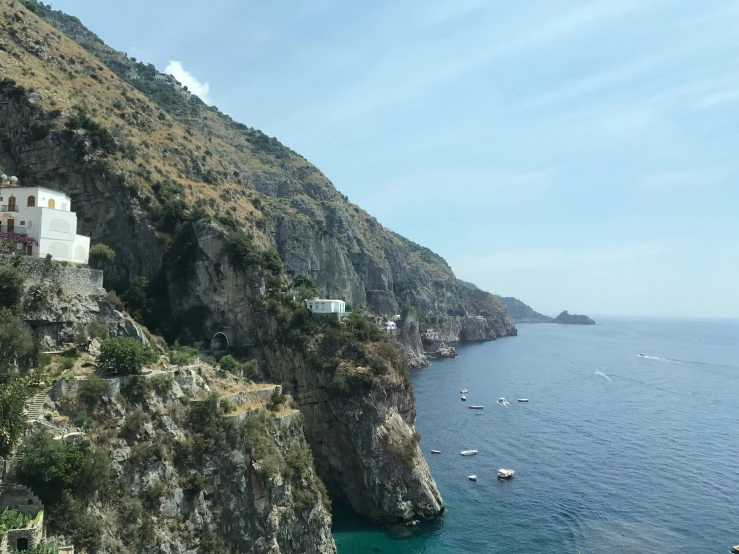 a village by the ocean and boat in the water