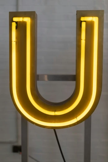 a neon sign that says u hanging on the wall