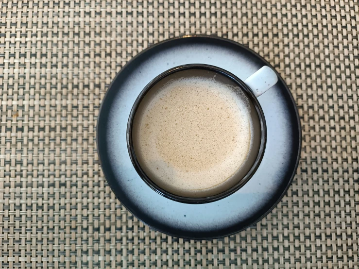 an empty cup of coffee with some liquid inside