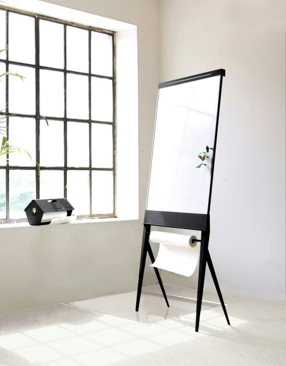 a white and black art easel by a window