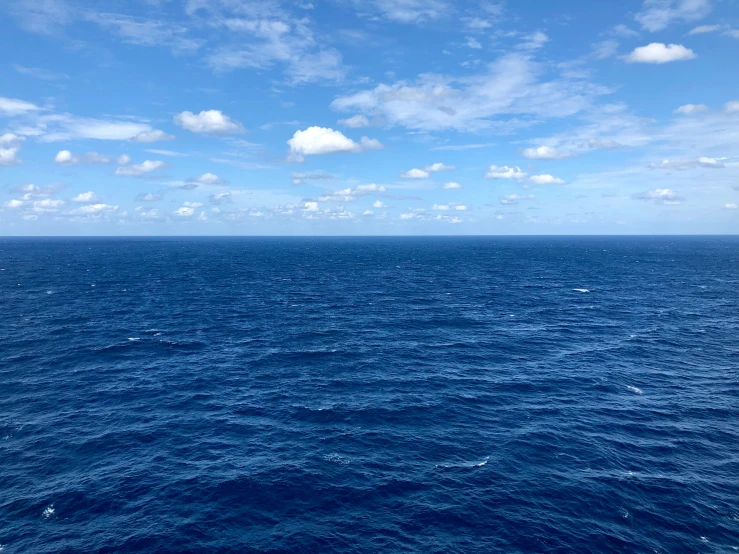 water and sky with clouds above a boat