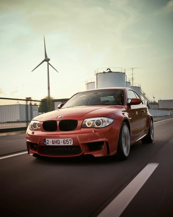 the bmw car is driving down the road