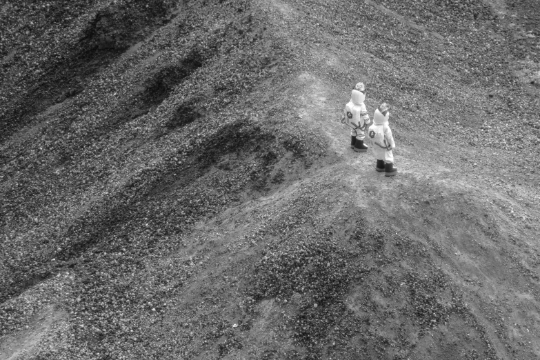 two people are walking up a hill together