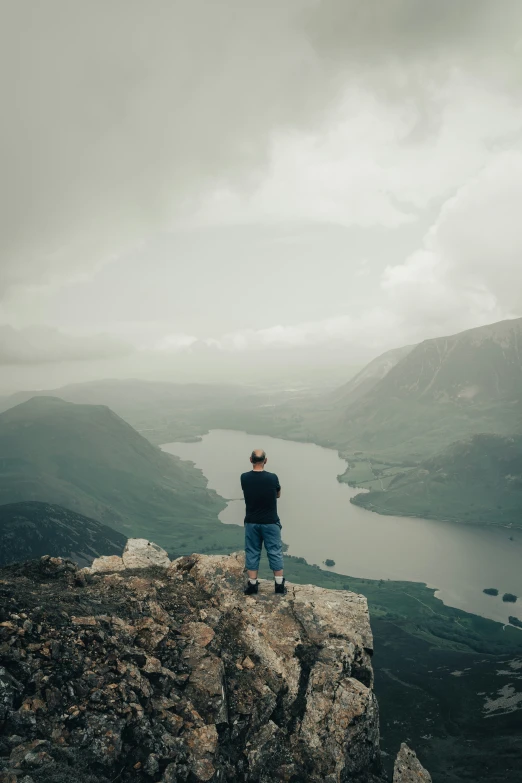 a man standing on top of a rocky cliff