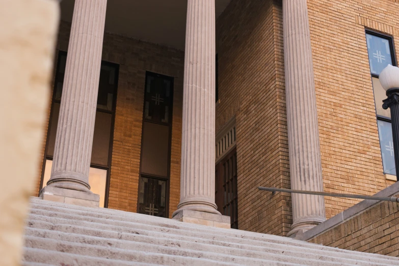 the building has two large pillars and some stairs