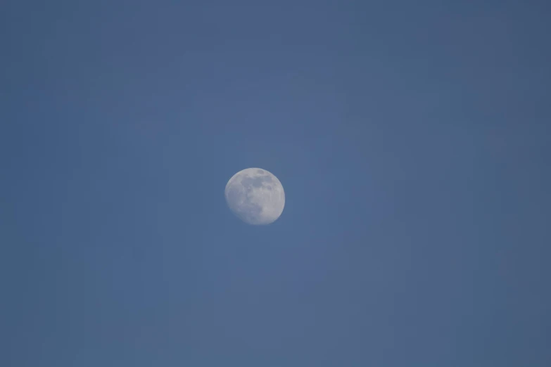 the moon is visible over a clear sky