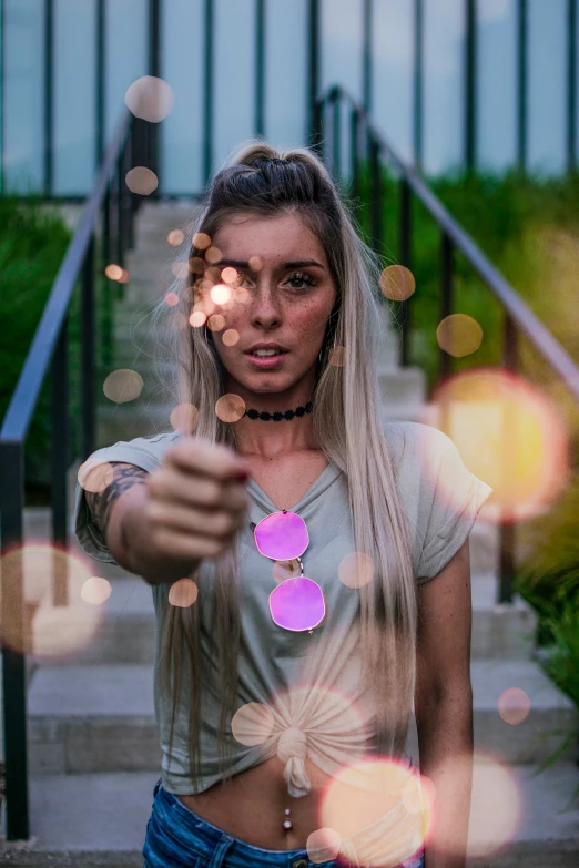 woman with large pink circle necklace near staircase