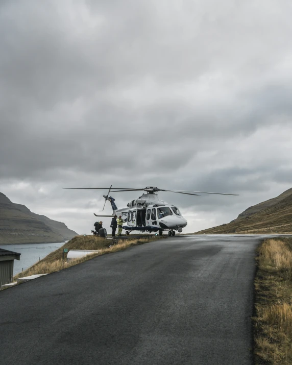 a small helicopter sitting on the side of a road