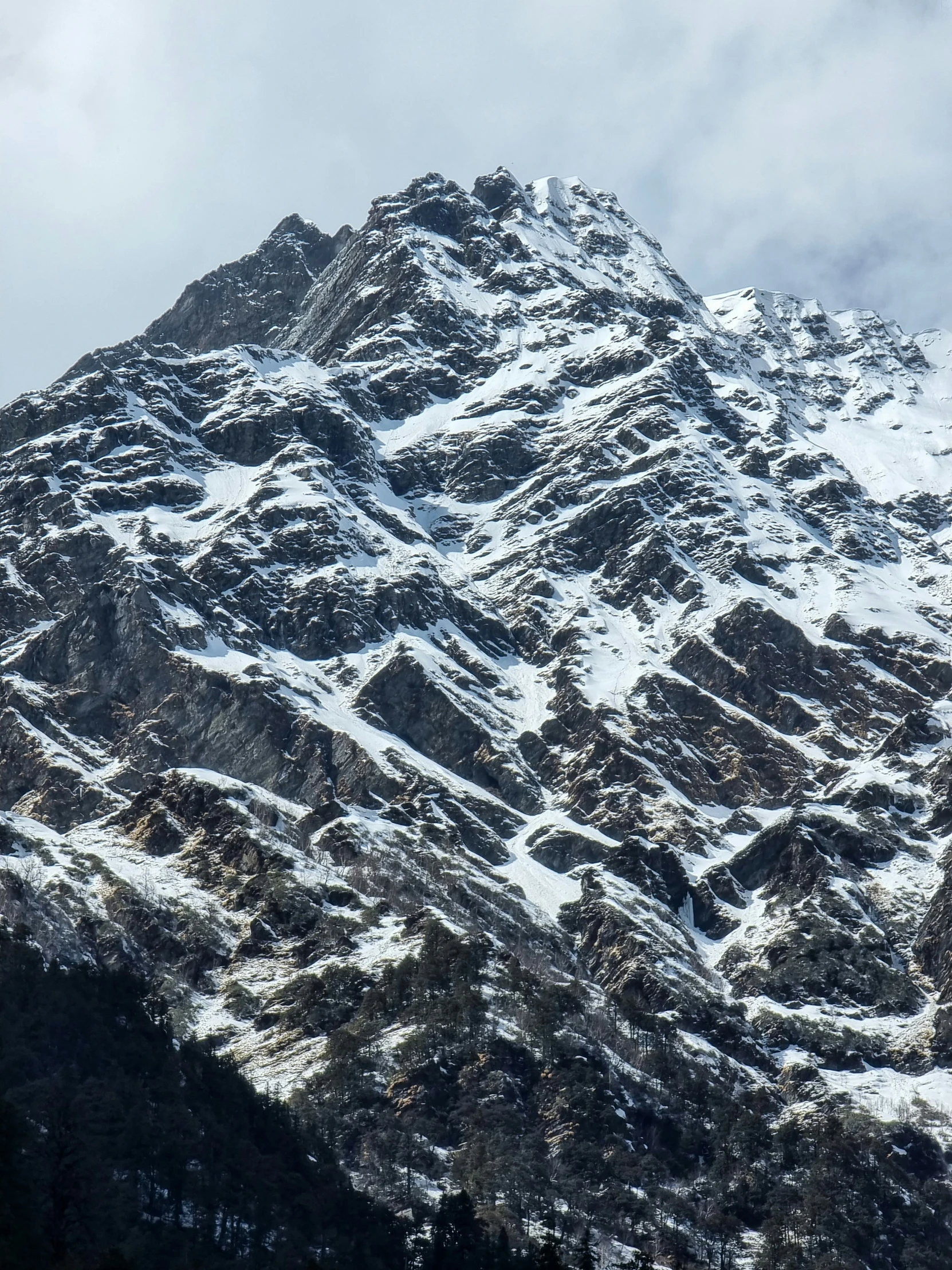 the top of the mountain is completely covered in snow