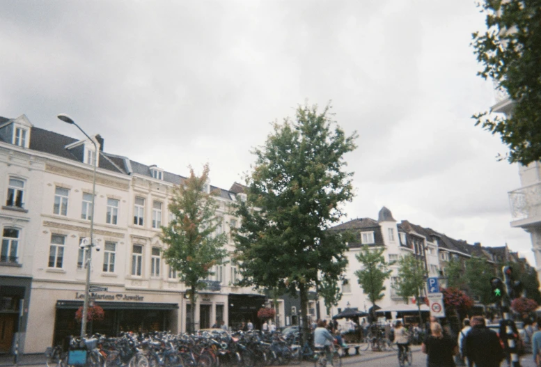 people are walking in a downtown city, with many buildings