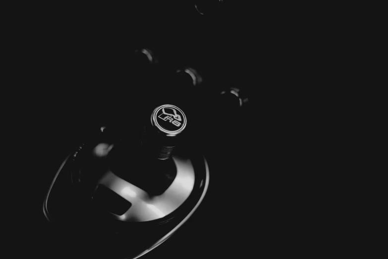 the dark night shows a car bumper with a circular symbol