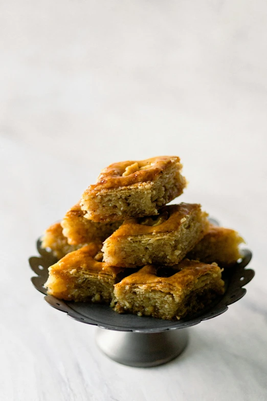 stack of short - form cut squares on a cake plate