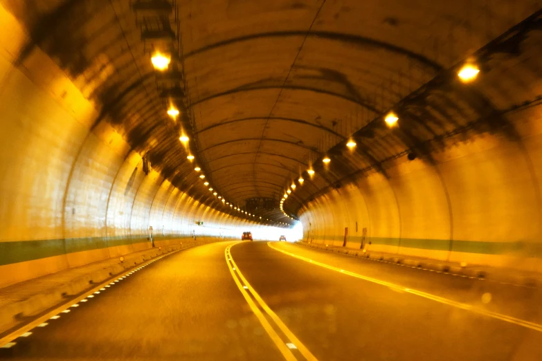 the view inside of a tunnel with lights in it