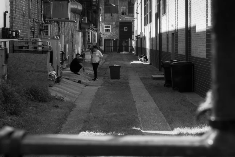 a woman walking down a sidewalk with her bag