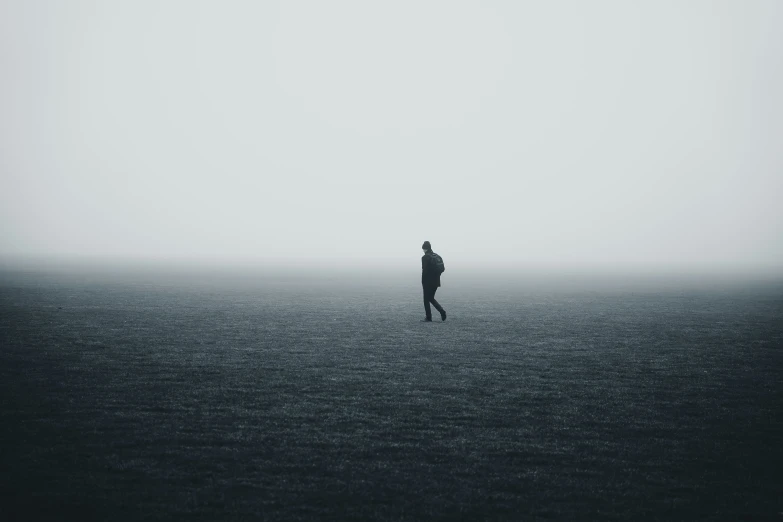 person on the foggy beach in the distance