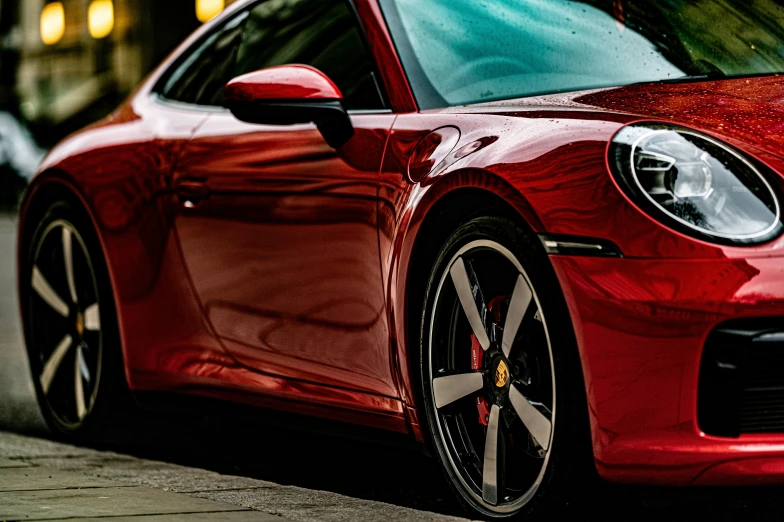 a red sports car parked next to a curb