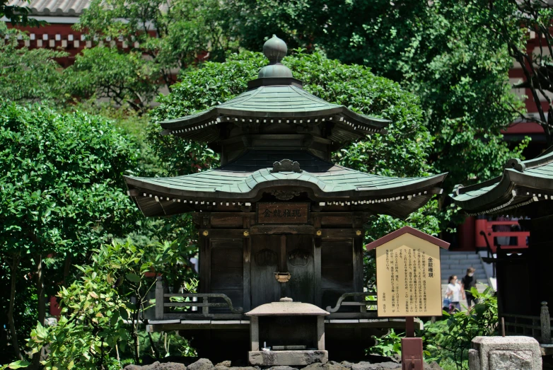 a small shrine with rocks surrounding it near some trees