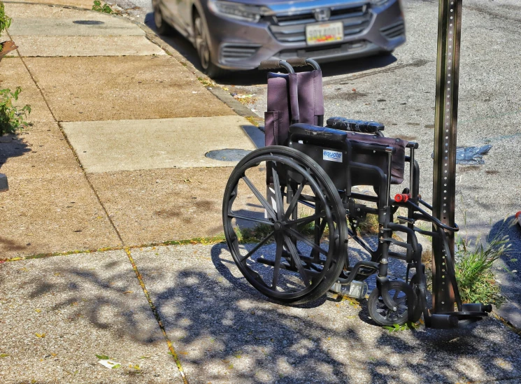 a parking meter and wheelchair are located next to each other