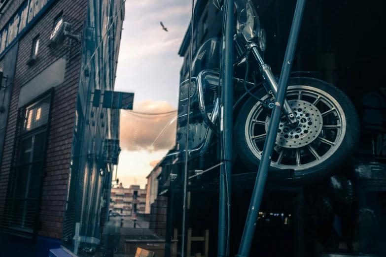 a car wheel hangs from the side of a building