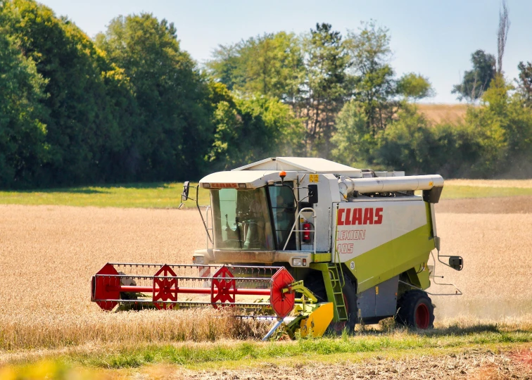 a tractor on a large farm field is preparing a meal