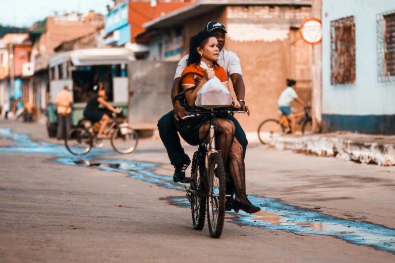 the woman rides her bike in the street