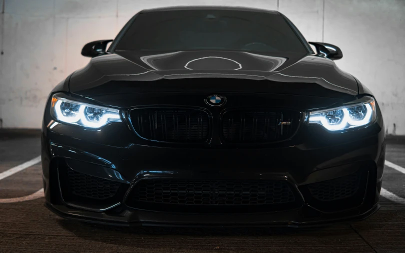 the headlights on a car are glowing and black