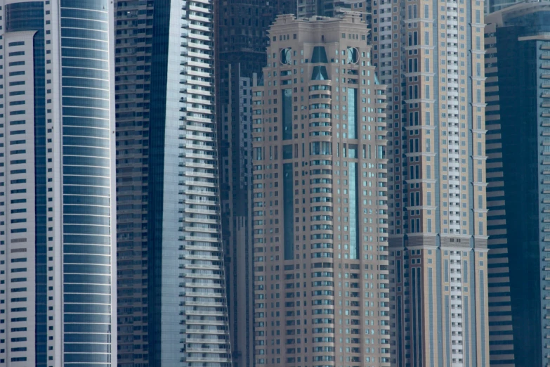a plane flies low over several very tall buildings