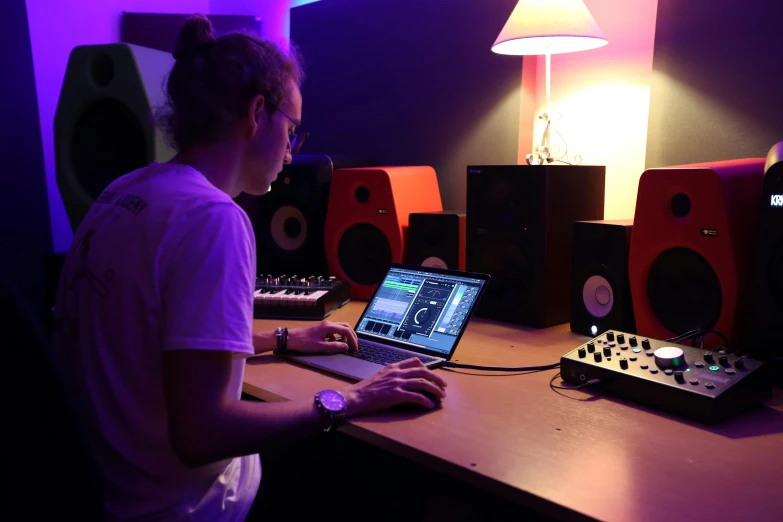 a person works at a desk with speakers