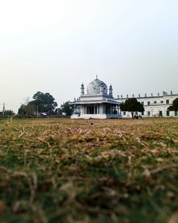 a building and many trees in a field