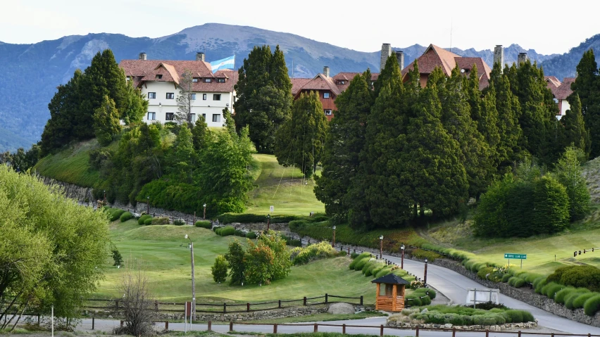 the building is in a residential neighborhood surrounded by mountains