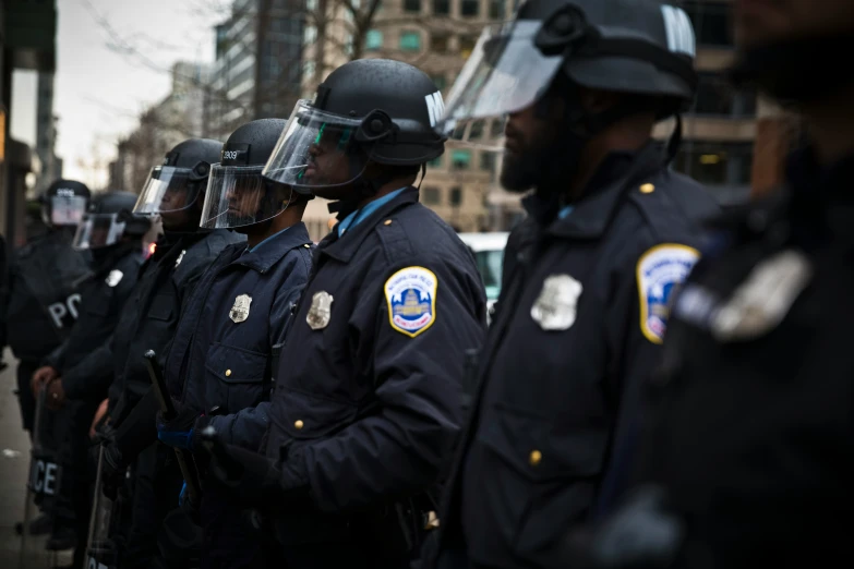 several police officers standing with their uniforms on