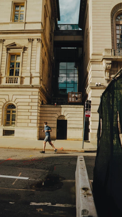 a person walking by a very tall building