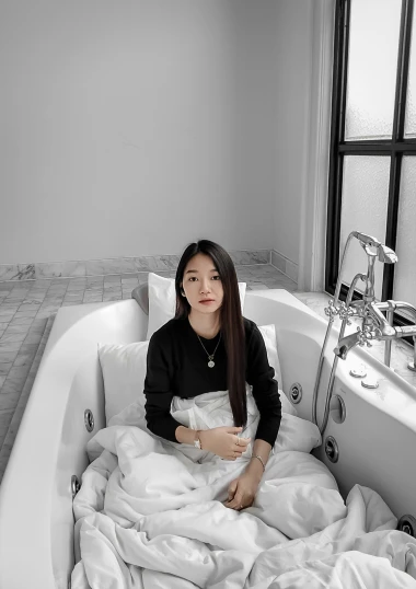a woman that is sitting in a bathtub