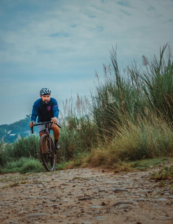 the man is riding his bike up the hill