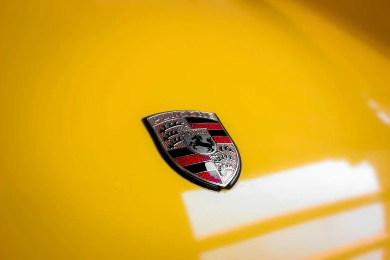 this is a po of a yellow car with emblem