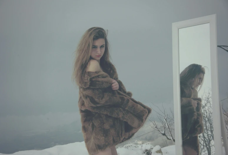 the young woman is wearing a fur coat