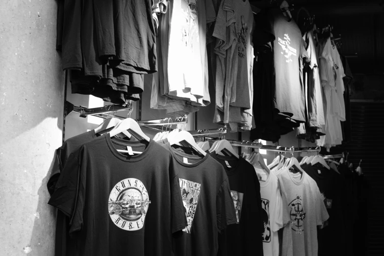 black and white po of shirts hanging on racks