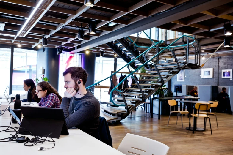 a group of young people in an open air office