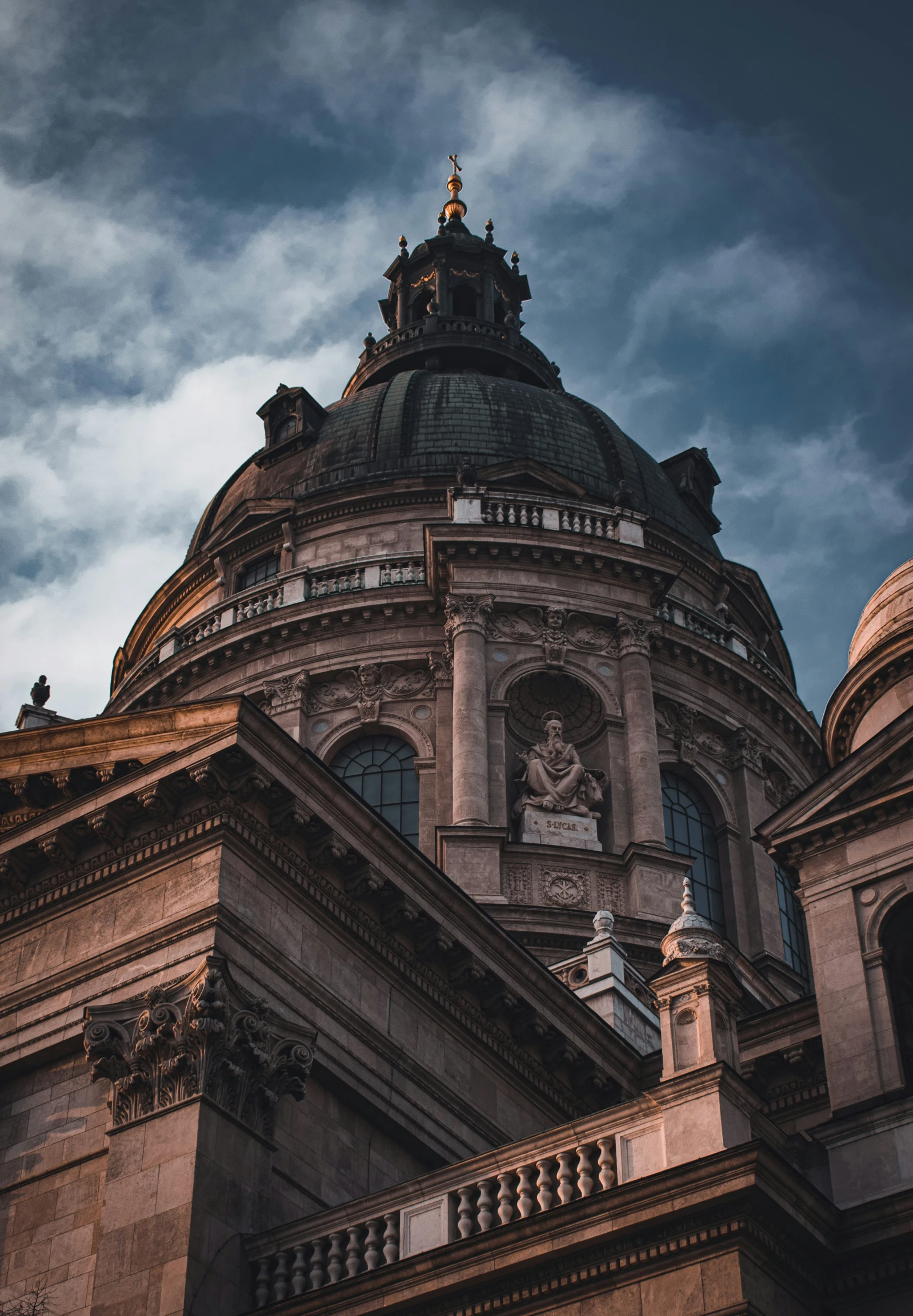 a view of the top part of an old building under a cloudy sky