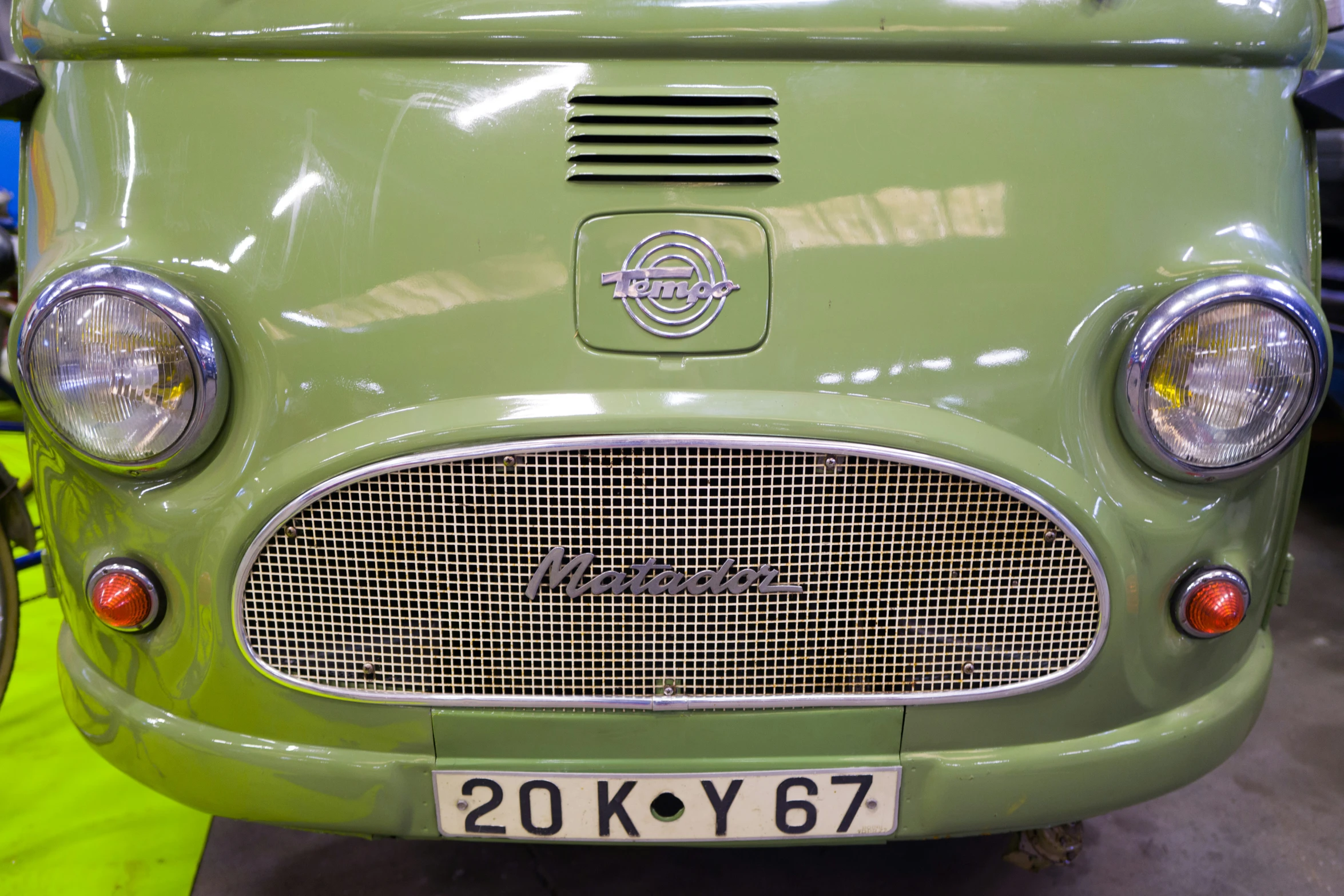 a close up of an old fashioned green truck