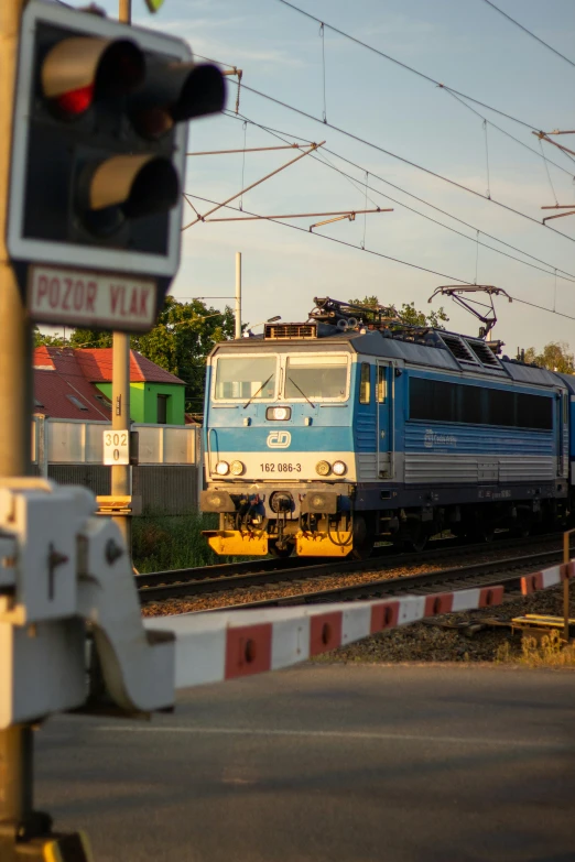 an electric train stopped on the tracks at a station