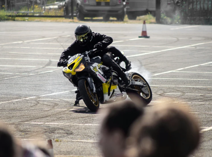 a person is riding on a yellow and black motorcycle